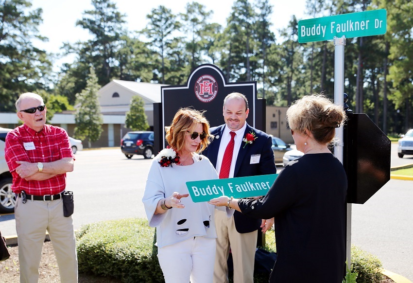 A road on East Mississippi Community College’s Scooba campus has been named after the late Buddy Faulkner, an EMCC alumnus. Here, Faulkner’s widow, Tina Faulkner, is presented with a duplicate road sign by EMCC Director of Alumni Affairs and Foundation Operations Gina Cotton. A road on East Mississippi Community College’s Scooba campus has been named after the late Buddy Faulkner, an EMCC alumnus. Here, Faulkner’s widow, Tina Faulkner, is presented with a duplicate road sign by EMCC Director of Alumni Affairs and Foundation Operations Gina Cotton.